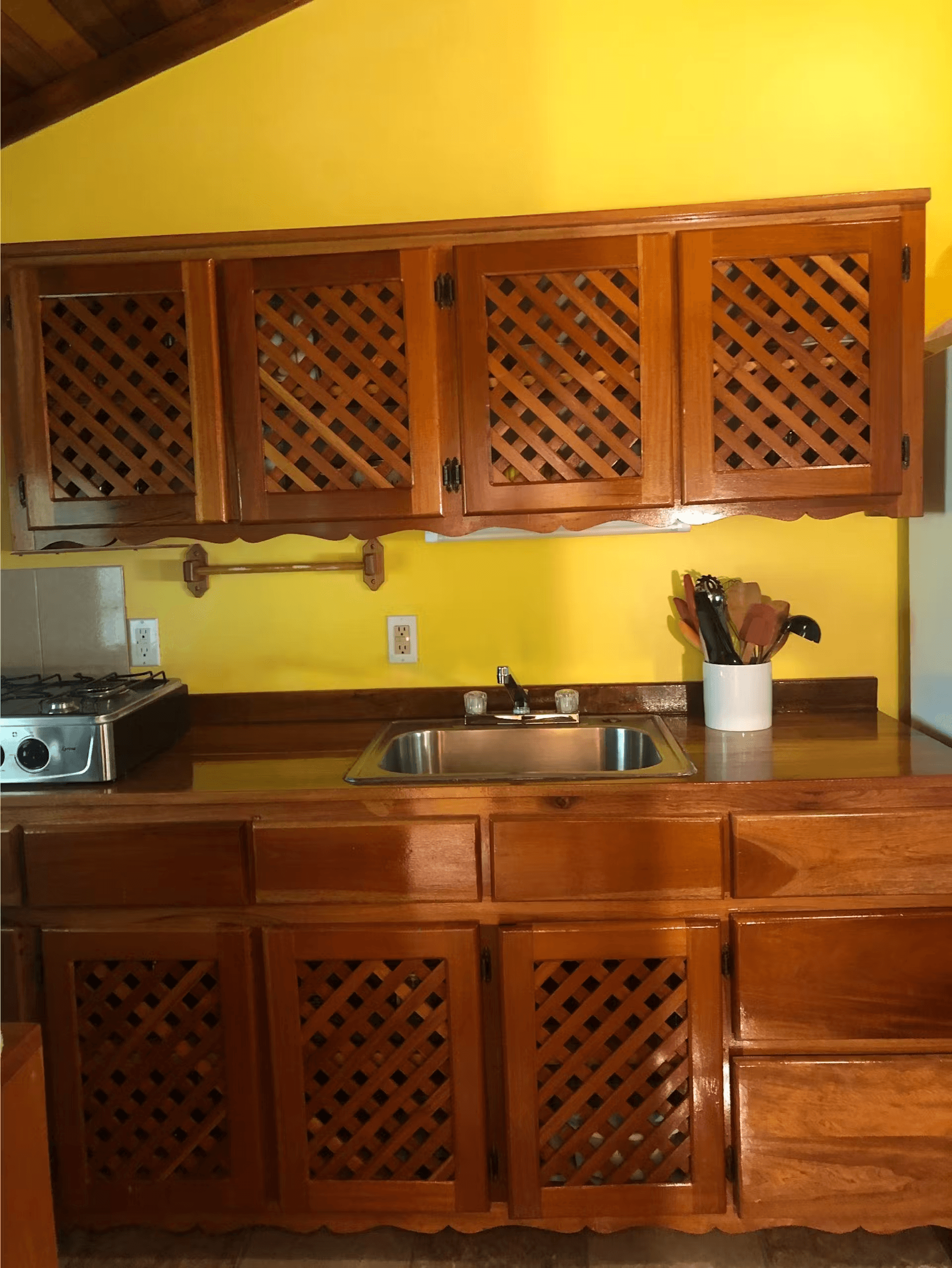 Kitchen with richly finished wood cabinets, sink, and tool caddy