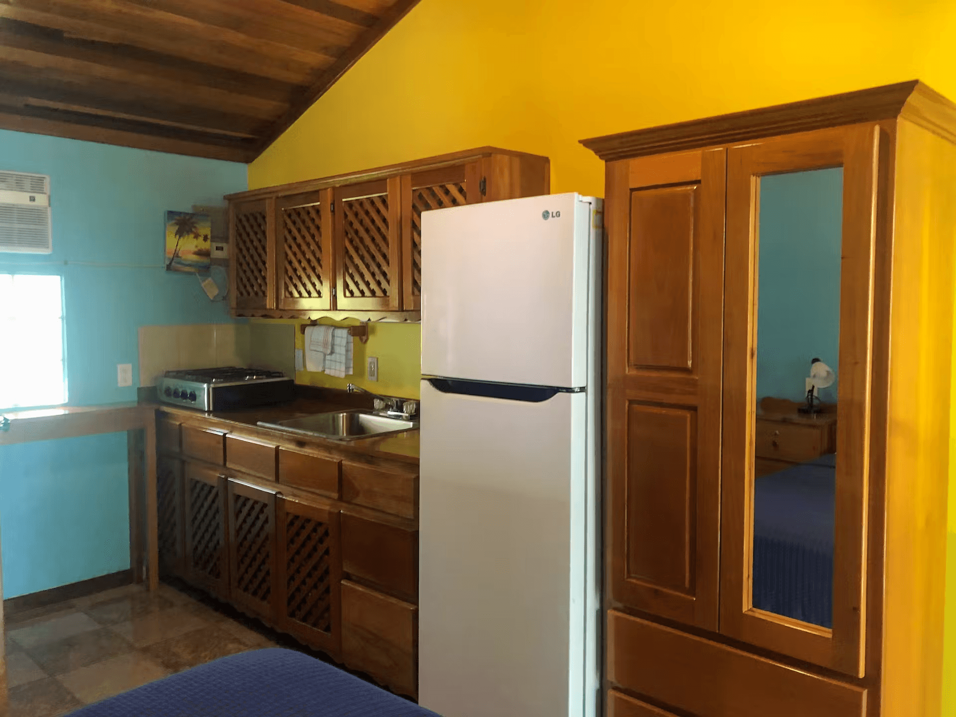 Kitchen with beautifully finished wood cabinetry, refrigerator, and sink