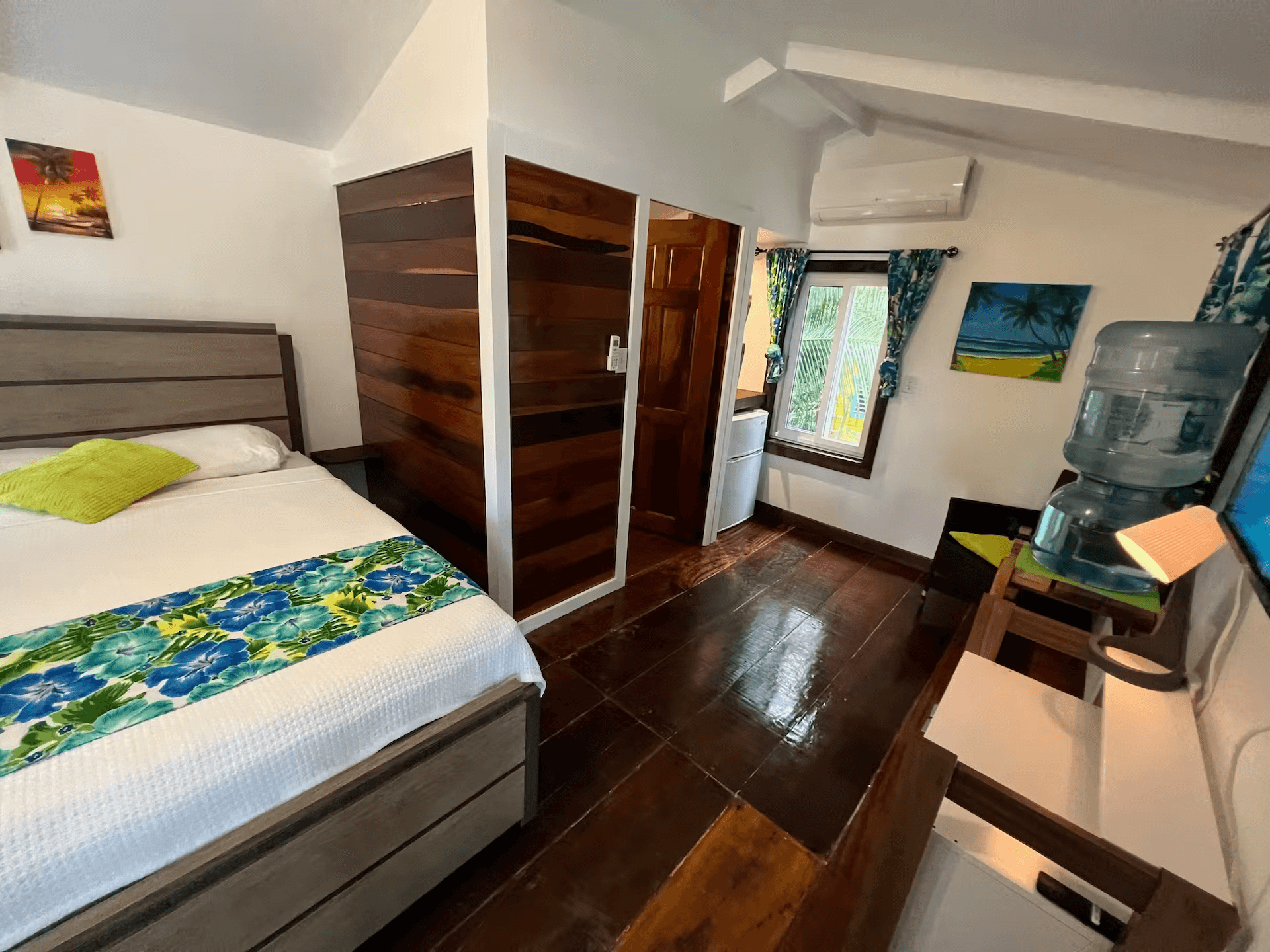 Bedroom with inviting queen-size bed and beautifully finished hardwood floors,
