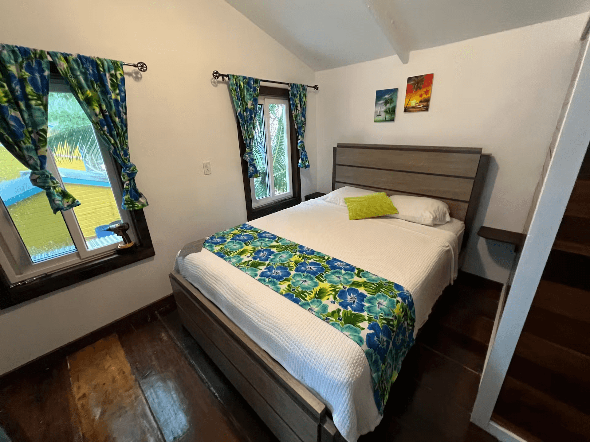 Bedroom with queen bed and stunning Belizean hardwood floors