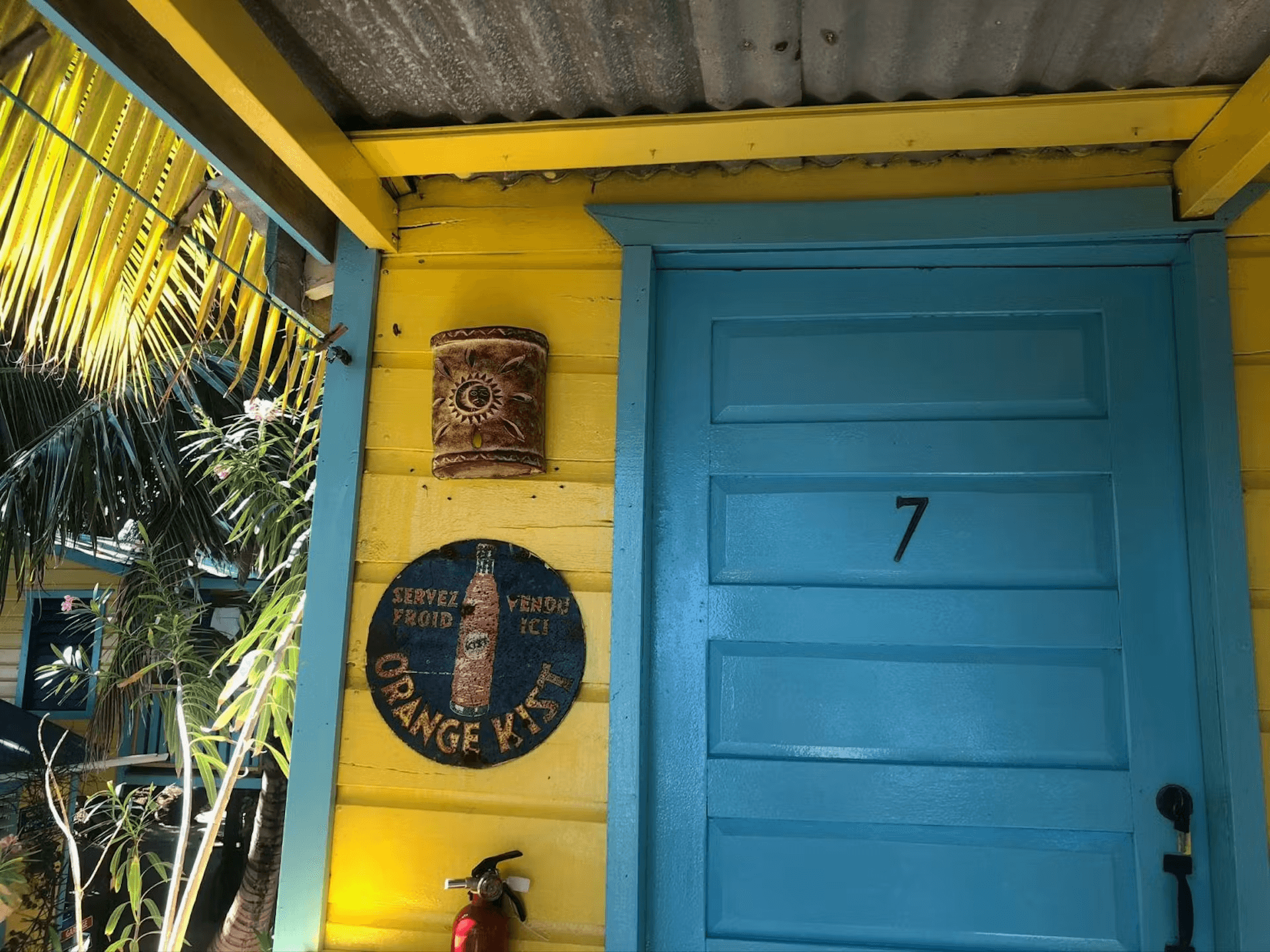 Bright blue front door with black number 7